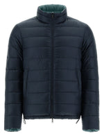 The Herno Men's Nylon Ultralight Reversible Jacket by Herno is a navy blue puffer jacket with a high collar and front zipper closure. It features horizontal quilted stitching and has green interior lining, making it water-resistant and perfect for versatile style while staying dry.