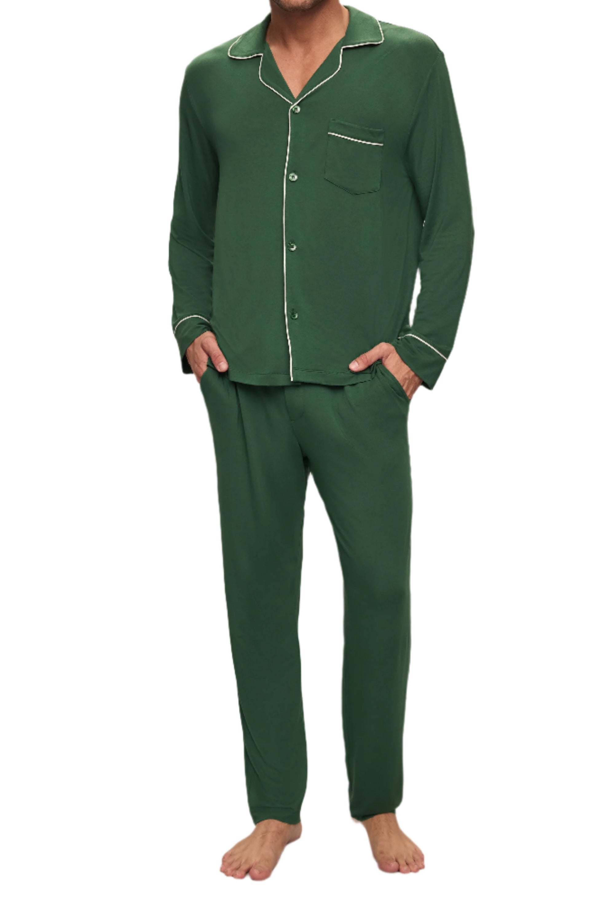 A person models the Eberjey Willam Long PJ Set in dark green with white piping, made from sustainable TENCEL™ Modal. The stylish button-up shirt and pants provide exceptional temperature regulation, as they stand barefoot against a plain background.