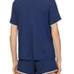 A person is shown from the back, wearing Eberjey's Frida Relaxed Short PJ Set in navy blue with white trim on the collar, sleeves, and boyfriend-fit shorts for a comfortable and relaxed look.