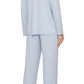A person is seen from the back wearing the Eberjey Gisele Rib Long PJ Set, a light blue sleep set featuring an elastic waistband and button-down top, barefoot.