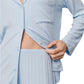 A person wears the Eberjey Gisele Rib Long PJ Set—a light blue, ribbed button-down top and pants—holding the shirt slightly open at the waist.