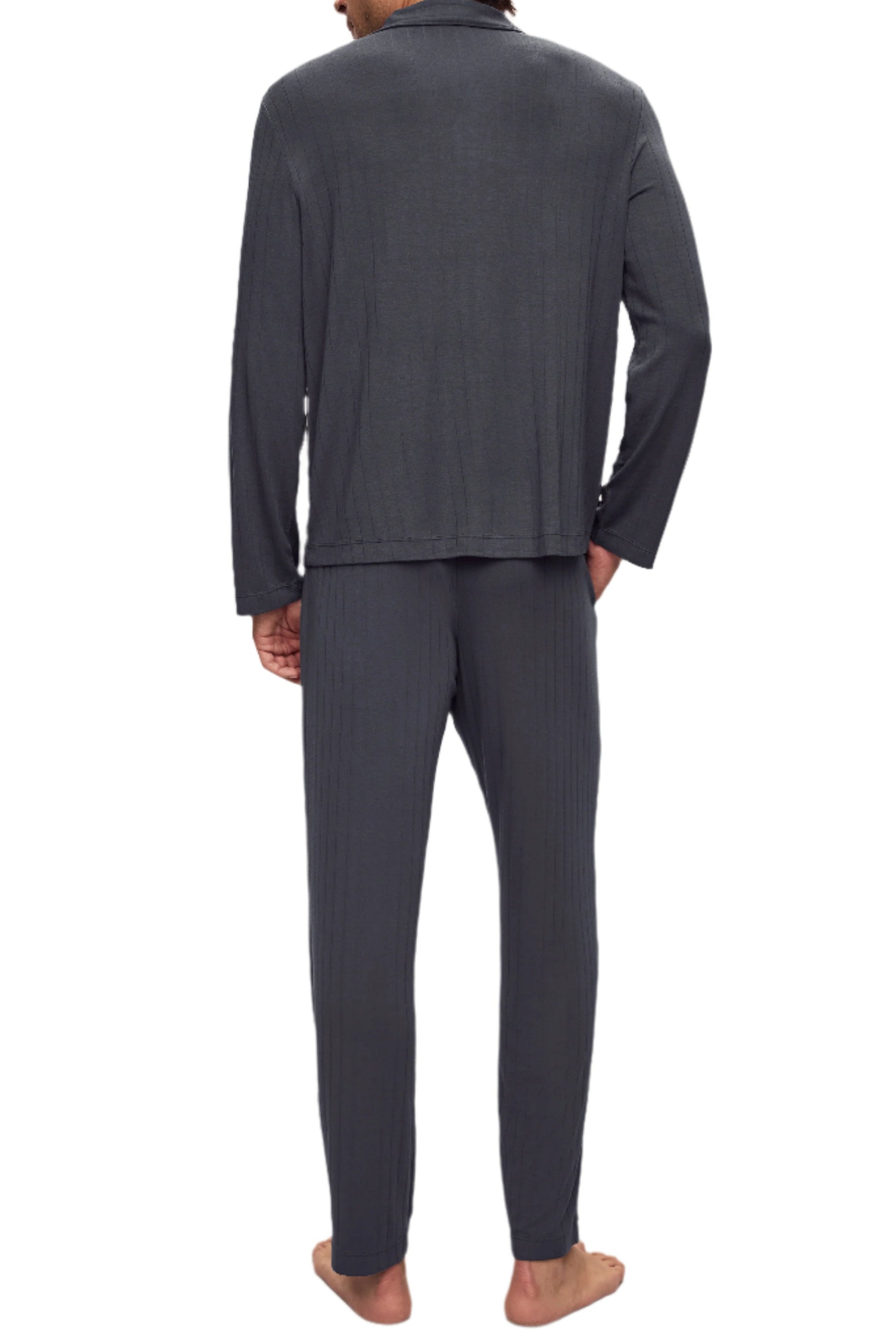 The person is wearing the Eberjey Willam Ribbed Long PJ Set, featuring breathable TENCEL™ Modal fabric and an elastic waistband, while standing barefoot and facing away.