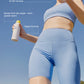 A woman in a blue sports outfit holds Supergoop Play Antioxidant Mist SPF 50 with Vitamin C, 6 fl oz, outdoors, with text highlighting water resistance, 360° sprayability, and a vegan formula for radiant skin.