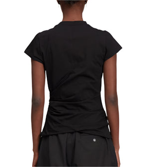 A person is shown from the back wearing a 3.1 Phillip Lim Draped Short Sleeve T-Shirt and black pants, capturing city elegance against a white background.