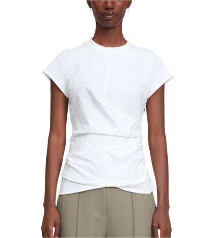 A person wears a 3.1 Phillip Lim Draped SS T-Shirt, a short-sleeve white top with subtle pleats and an asymmetric neckline, paired with high-waisted light olive green tailored trousers.