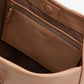 The Go Large Shoulder Bag by 3.1 Phillip Lim is an open beige handbag revealing a spacious interior, featuring premium leather construction, a zippered pocket, and a button closure at the top.