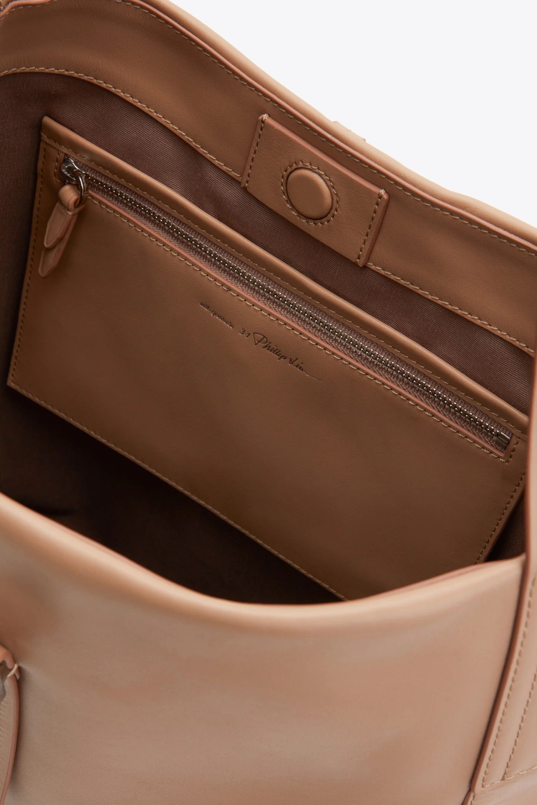 Explore the 3.1 Phillip Lim Go Large Shoulder Bag, crafted from premium beige leather. It offers a roomy interior with an interior zippered pocket and a secure snap closure.