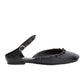 Side view of the ID Mary Jane Flat Leather Craft by 3.1 Phillip Lim, a classic black flat shoe featuring an ankle strap, sculpted toe, and small decorative bows along the edge.