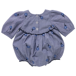 The Pink Chicken Baby Girls' Rowan Bubble is a blue romper with short puffed sleeves, back buttons for easy changes, a ruffle detail, and a charming blue floral pattern.