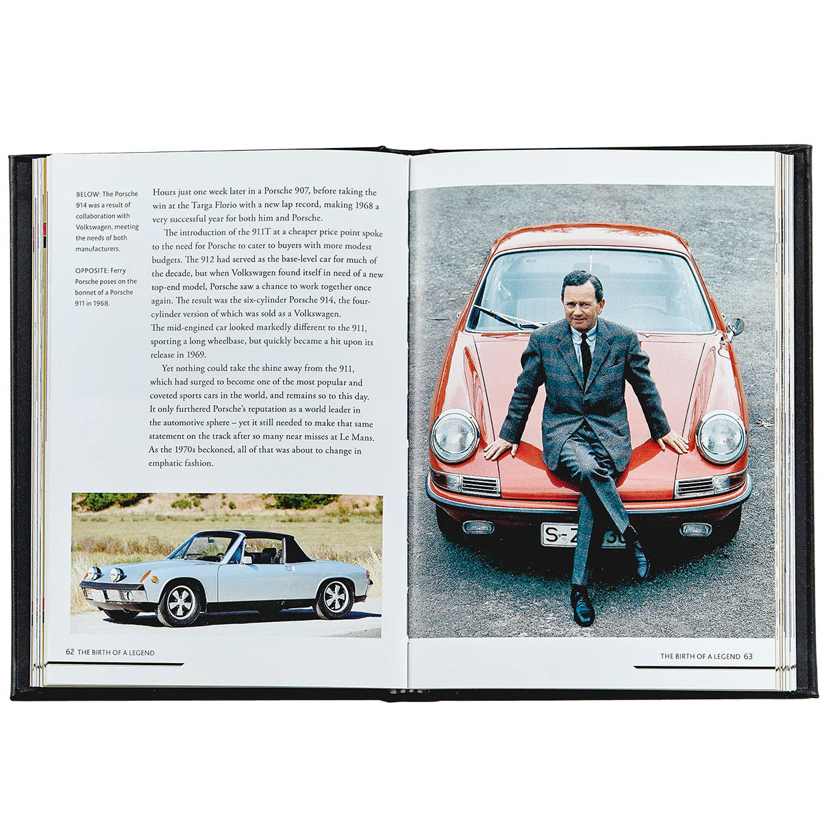 The Story Of Porsche Black Leather Book by Graphic Image features a man in a suit leaning on a red vintage car on one page and a sleek Porsche convertible on the other, highlighting luxury and race car manufacturing.