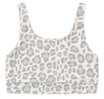 Rylee & Cru Girls’ Swift Sports Bra features a classic fit with a white scoop neck and light gray leopard print pattern, shown laid flat against a white background—perfect for everyday wear.