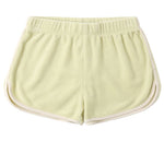 The Girls' Track Short by Rylee & Cru is a light yellow terry cloth short with an elastic waistband and white trim, shown flat with the back up—ideal summer shorts for relaxed comfort.