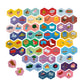 Eeboo’s Rhyming Words Hexagon Pairing Puzzles feature vibrant hexagon tiles illustrated by Sarah Walsh, each labeled with a word and depicting objects or animals; the tiles are grouped by background color and arranged in overlapping rows, creating an engaging pre-literacy activity to build essential skills.