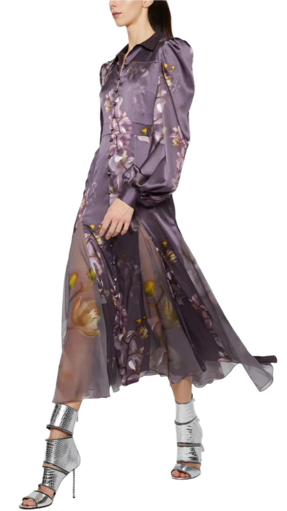 A person wearing a Prabal Gurung Chiffon Panel Shirtdress in a long, flowing lavender floral design, paired with silver high-heeled shoes.