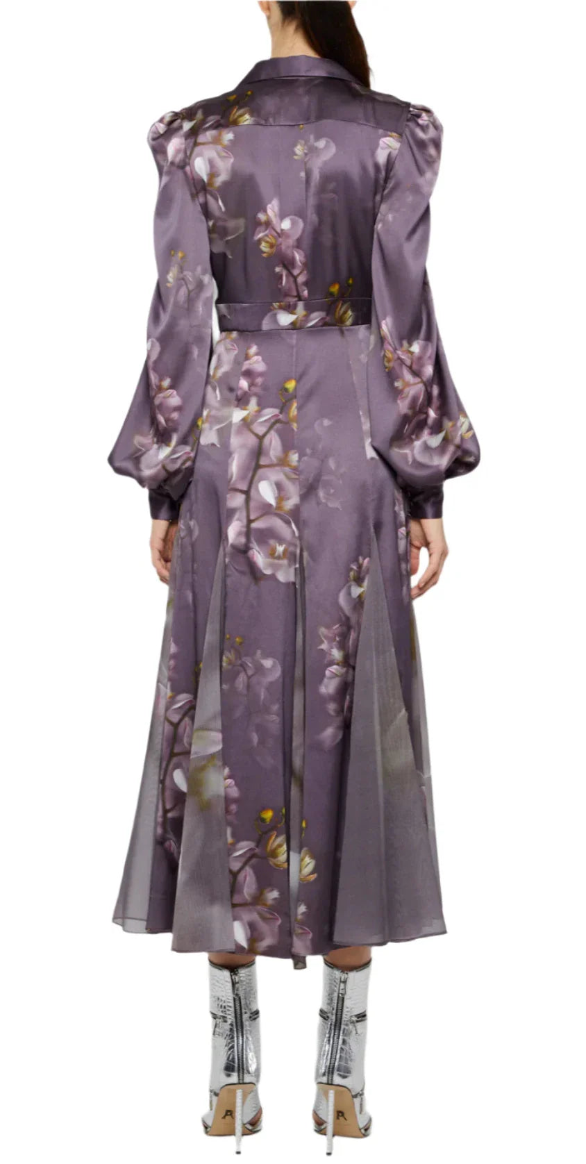 Back view of a person wearing the Prabal Gurung Chiffon Panel Shirtdress, featuring a long purple floral pattern with puffed sleeves, crafted from luxurious chiffon, paired with silver high-heeled boots.