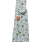 A person in side profile wears the Prabal Gurung Huma Maxi Dress—featuring a flattering fit, floral pattern, and shoulder cutouts—with white ankle boots against a white background.