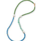 The Cabana Necklace by Lizzie Fortunato shines with green, blue, and aqua semiprecious beads, accented by large white pearls and a gold clasp, making it a vibrant addition to any jewelry collection.