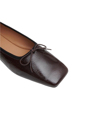 Close-up of the Mansur Gavriel Square Toe Ballerina in dark brown lambskin, featuring a small bow on the toe, displayed against a white background.