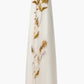 The Jools Dress by Altuzarra is a sleeveless, floor-length white silk dress with a vertical botanical print showcasing yellow and brown thistle flowers and leaves on the front.
