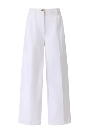 The Dash Pant by Altuzarra features a high waist, front button and zip closure, pressed center creases, and a modern cropped barrel-leg silhouette in wide-leg white tailoring.
