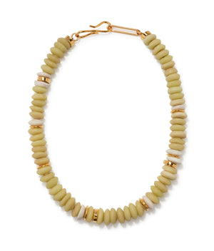 The Lizzie Fortunato Laguna Necklace showcases round, flat recycled glass beads in beige, accented with gold spacer beads and finished with a gold clasp.