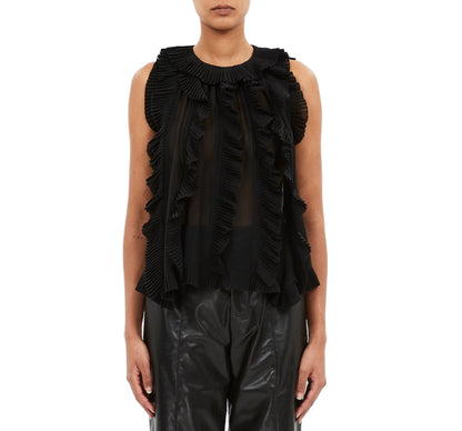 A model wears the Ulla Johnson Sabra Cascading Ruffle Top in black, paired with black leather pants, shown from the front against a white background.