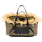 The Lali Small East West Tote by Ulla Johnson is a hand-woven raffia bag with black leather handles and trim, enhanced by beige straw fringe accents along the opening for extra style.