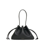 The Mansur Gavriel Drawstring Pouchette is a black compact Italian leather handbag with two top handles, side knots, and minimal gold branding at the bottom—ideal for carrying your essentials.