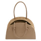 The Fortuna Bowling Bag by Mansur Gavriel is a taupe Italian leather top-handle bag featuring two handles, a curved top, and a partially open zipper that reveals a spacious suede interior.
