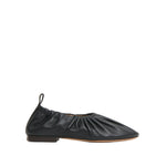 The Mansur Gavriel Ruched Ballerina is a black Italian leather flat featuring a gathered design, pull-tab at the heel, padded insoles, and a low-profile sole, shown in side view on a white background.