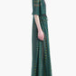 A woman in an elegant, floor-length Thessaly Dress by Altuzarra—featuring a green hue, short sleeves, and a subtle vertical pattern—stands in profile against a white background.