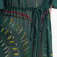 Close-up of the Thessaly Dress by Altuzarra—an elegant green sheer dress with a drawstring waist, featuring a leafy and abstract multicolored pattern.