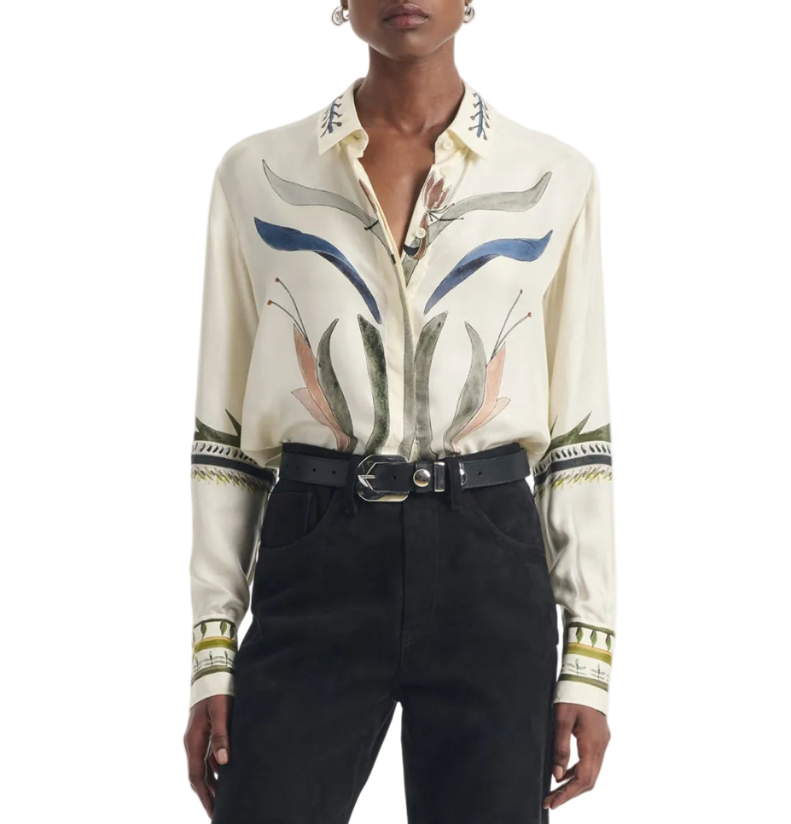 Wearing the Altuzarra Chika Top—a cream-colored silk blouse featuring abstract floral patterns and a concealed button closure—tucked into high-waisted black pants and accessorized with a black belt.