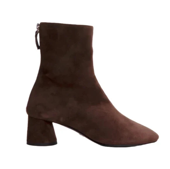 The Proenza Schouler Glove Suede Boot is a brown suede ankle boot designed in the stylish glove boots fashion, featuring a convenient back zipper and a mid-height block heel.