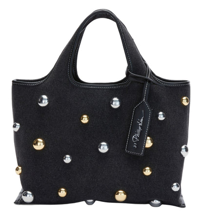 The 3.1 Phillip Lim Washed Denim Mini Market Tote is a small handbag with short handles, adorned with gold and silver spherical studs and finished with a visible designer tag on one handle.