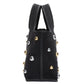 Side view of the 3.1 Phillip Lim Washed Denim Mini Market Tote, featuring black fabric with white stitching and chic gold and silver dome stud accents.