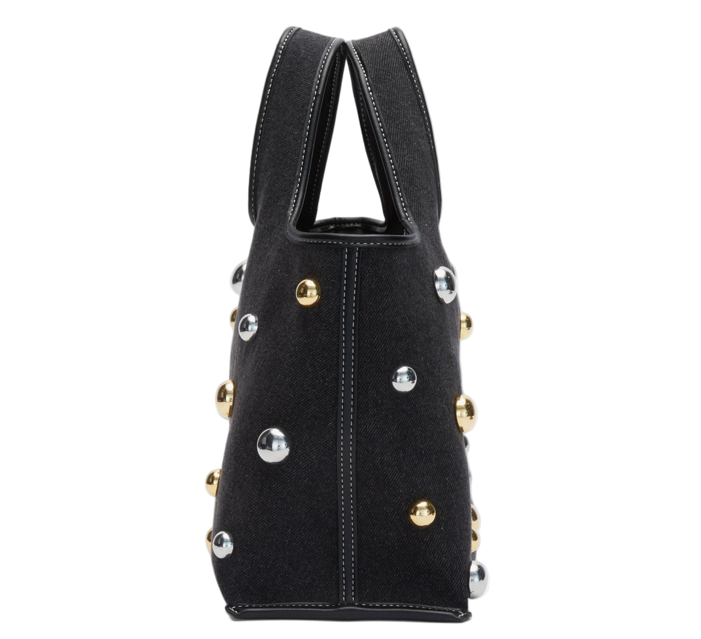 Side view of the 3.1 Phillip Lim Washed Denim Mini Market Tote, featuring black fabric with white stitching and chic gold and silver dome stud accents.