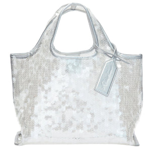 The Mesh Sequin Mini Market Tote by 3.1 Phillip Lim features silver sequins, short handles, and a matching tag, creating a sparkling accessory against a white backdrop.