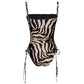 The Palms Tarangire One Piece by Johanna Ortiz is a beige and black zebra print swimsuit with a body-core silhouette, adjustable spaghetti straps, and ruching with side ties.