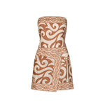 The Raiz Ritual Mini Dress by Johanna Ortiz is a strapless brown and beige linen mini dress, featuring a bold JO print, swirling tribal patterns, and a chic wrap-effect skirt for a fitted look.
