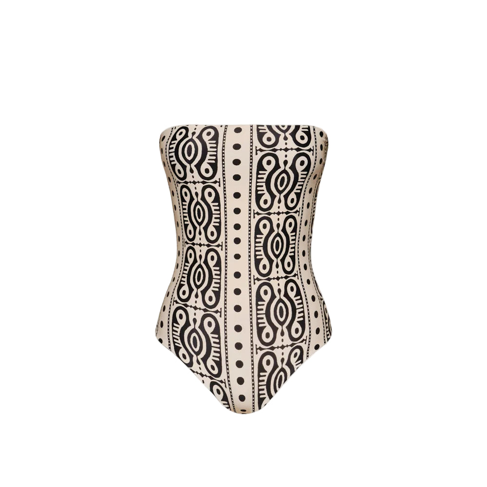 The Johanna Ortiz Tribal Alta Mar One Piece is a strapless swimsuit featuring a bold black geometric pattern on beige, evoking chic resort style and displayed against a plain white background.