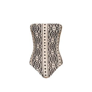 The Johanna Ortiz Tribal Alta Mar One Piece is a strapless swimsuit featuring a bold black geometric pattern on beige, evoking chic resort style and displayed against a plain white background.