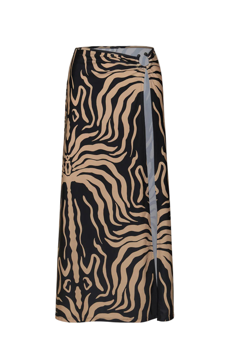 The Palms Nuevo Destino Midi Skirt by Johanna Ortiz features a beige and black zebra print, Lycra fabric, front slit, and ruched waist—ideal for resort styling or chic beachwear looks.