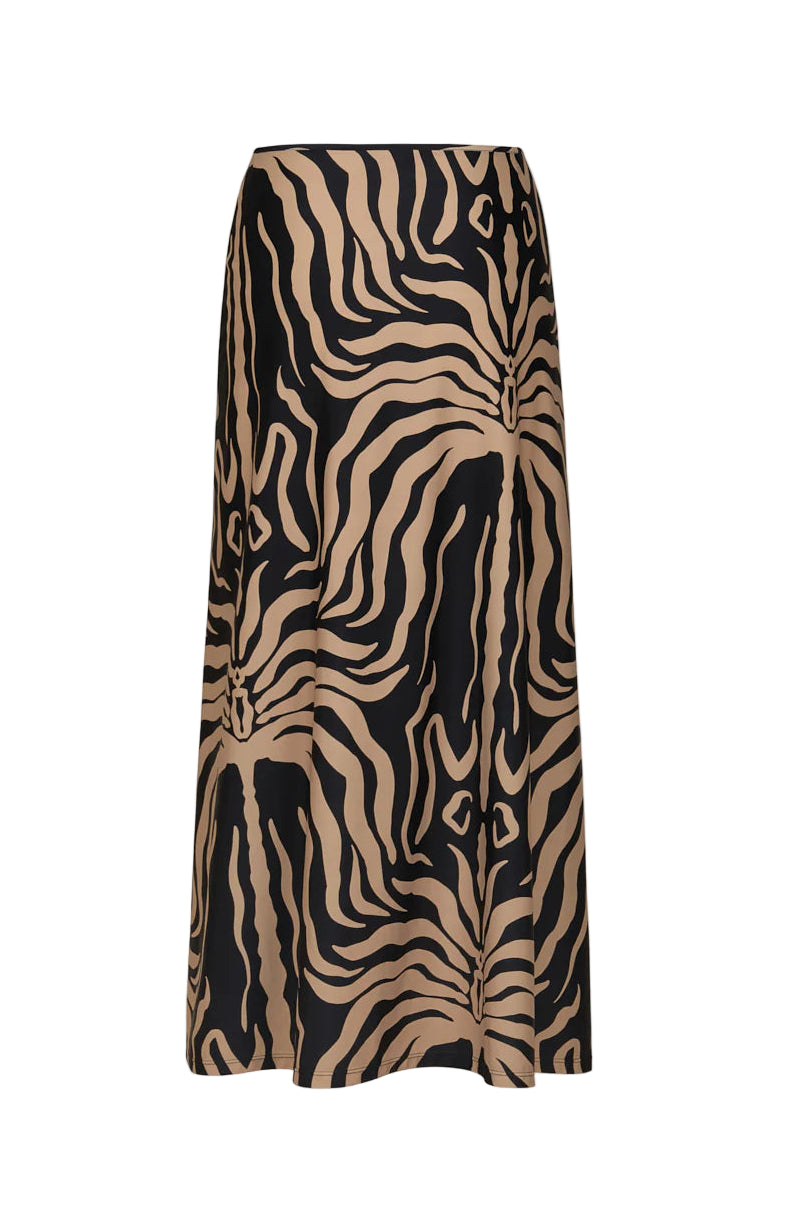 The Johanna Ortiz Palms Nuevo Destino Midi Skirt features a tan and black abstract zebra print on smooth Lycra fabric, offering a resort-ready style and shown against a plain white background.