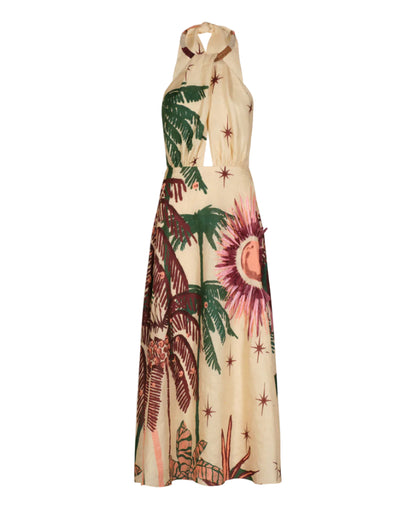 The Western Elements Ankle Dress by Johanna Ortiz is a sleeveless halter-neck design in beige, adorned with tropical botanical motifs—palm trees, stars, and a sunburst in green, brown, and purple tones.