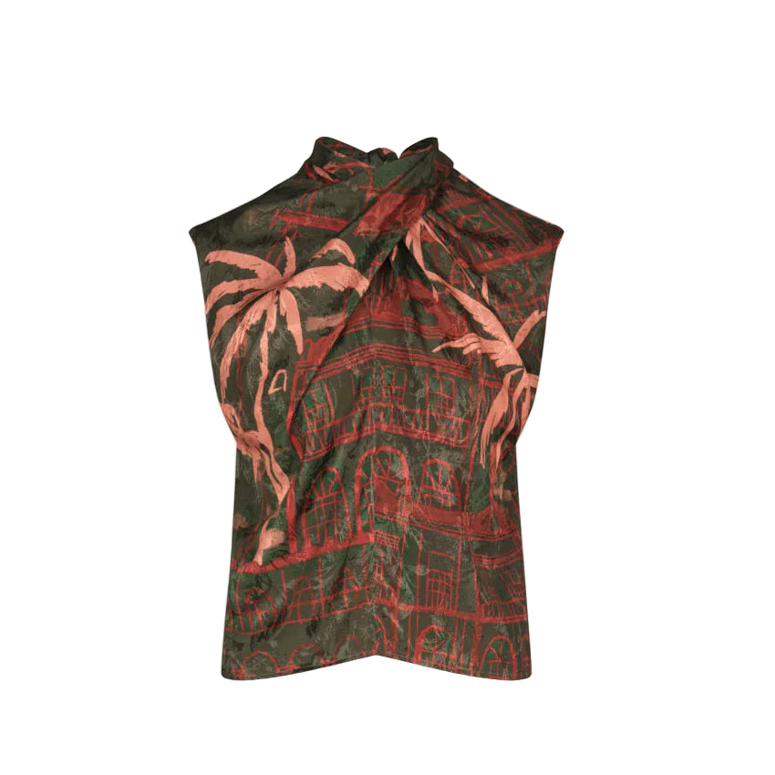 The Mystic Shore Top by Johanna Ortiz is a sleeveless top with a twisted halter neckline, made from printed jacquard showcasing the brand’s signature dark green and red palm tree and building print.