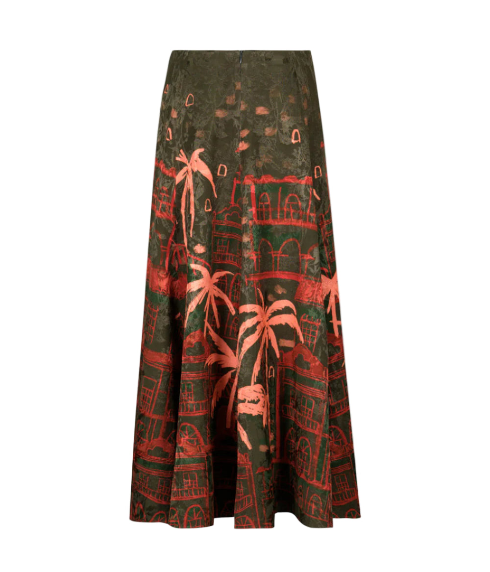 The Encanto De Isla Ankle Skirt by Johanna Ortiz is a high-waisted, ankle-length skirt with a flared silhouette, featuring a green base and red tropical cityscape print with palm trees and buildings.
