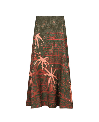 The Encanto De Isla Ankle Skirt by Johanna Ortiz features a high-waisted, ankle-length silhouette with a dark green base, adorned with pink and red palm tree and building prints.