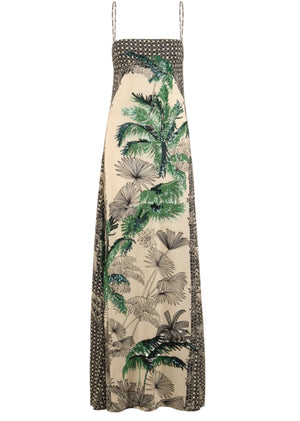 The Simbologia Floral Maxi Dress by Johanna Ortiz features a sleeveless design with thin straps, a cream base, black geometric borders, and green and black tropical motifs down the center for a striking look.