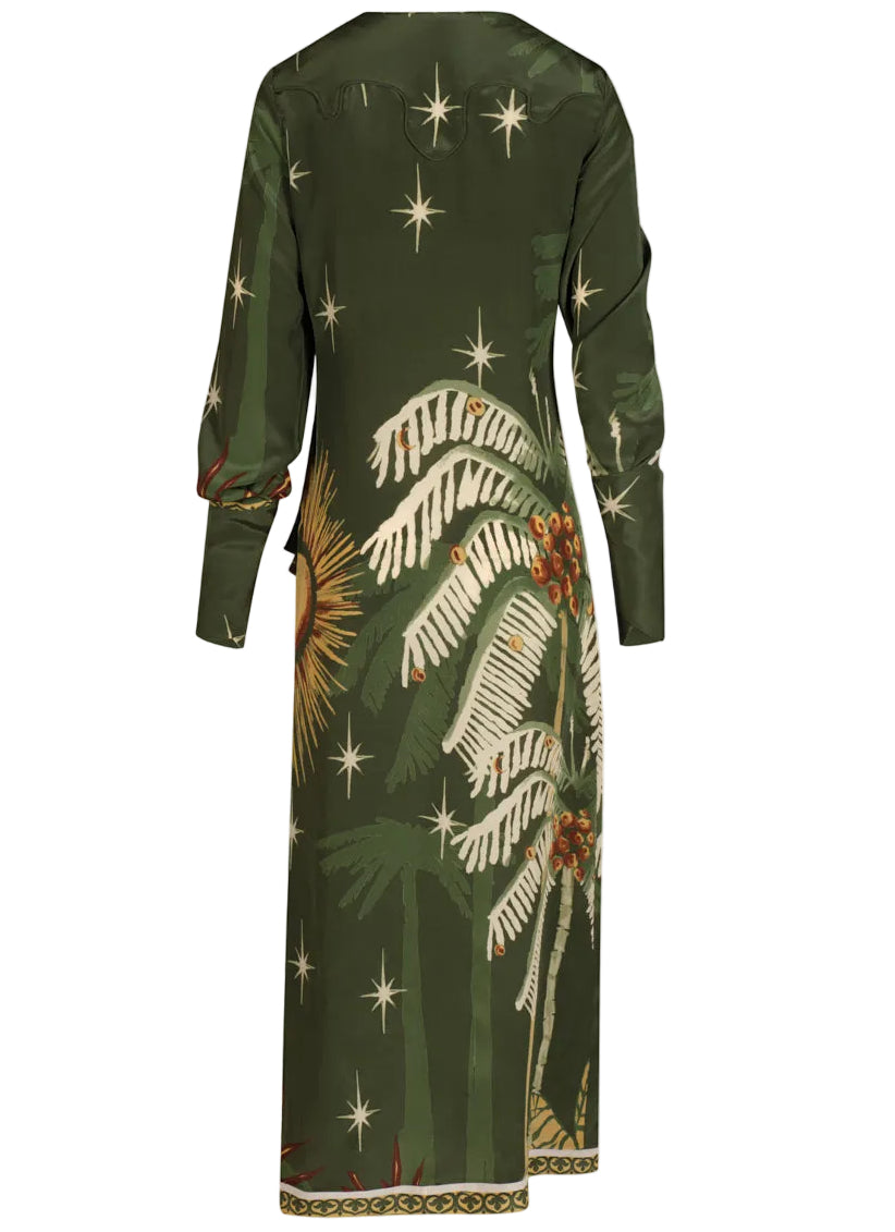 The Eternity Begins Wrap Dress by Johanna Ortiz is a long-sleeve green silk crêpe de chine dress featuring a JO print of palm leaves, stars, and berry clusters, shown from the back.